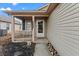 Inviting front entrance with covered porch, white door and neutral siding, creating a warm welcome to the home at 15214 Ten Point Dr, Noblesville, IN 46060