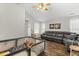 Bright living room with hardwood floors, neutral walls, and a comfortable sectional sofa, ideal for relaxation at 15214 Ten Point Dr, Noblesville, IN 46060