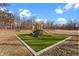 Community playground featuring a slide, climbing wall, and play area on artificial turf at 15214 Ten Point Dr, Noblesville, IN 46060