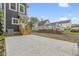 View of backyard with a concrete patio, lawn, and a dark gray house with white trim at 1538 Ringgold Ave, Indianapolis, IN 46203