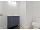 Bathroom featuring a blue sink and cabinet, white walls and hardwood floors at 1538 Ringgold Ave, Indianapolis, IN 46203