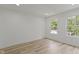 Bedroom with wood-look floors, white walls and trim, and large double windows at 1538 Ringgold Ave, Indianapolis, IN 46203