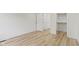 Bedroom with wood-look floors, white walls, and closet space at 1538 Ringgold Ave, Indianapolis, IN 46203