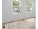 Bedroom with wood-look floors, white walls, and double windows overlooking the neighborhood at 1538 Ringgold Ave, Indianapolis, IN 46203