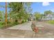 View of a home with gray siding, a small porch, concrete driveway, and partially landscaped yard at 1538 Ringgold Ave, Indianapolis, IN 46203