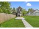 Attractive home featuring a fresh lawn, a gray exterior, and a concrete driveway at 1538 Ringgold Ave, Indianapolis, IN 46203