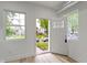 Bright foyer featuring white walls and light wood-look floors with a view of the home's exterior at 1538 Ringgold Ave, Indianapolis, IN 46203