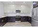 Kitchen features stainless steel appliances, white cabinets, and hardwood floors at 1538 Ringgold Ave, Indianapolis, IN 46203
