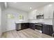 Kitchen features stainless steel appliances, white cabinets, and hardwood floors at 1538 Ringgold Ave, Indianapolis, IN 46203