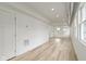 Spacious living room with a side entrance door, hardwood floors and white walls at 1538 Ringgold Ave, Indianapolis, IN 46203