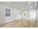 Bright living room features hardwood floors, fresh white paint and two large windows at 1538 Ringgold Ave, Indianapolis, IN 46203