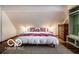 Bedroom featuring a comfortable bed, hardwood floors, modern decor, and ample storage space at 1647 N Tacoma Ave, Indianapolis, IN 46218