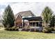 Expansive backyard featuring a brick home with a charming pergola-covered patio perfect for outdoor entertaining at 1805 Braeburn Dr, Carmel, IN 46032