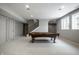 Spacious finished basement featuring a pool table, neutral walls, staircase and ample lighting at 1805 Braeburn Dr, Carmel, IN 46032