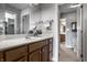 Bathroom with a white sink, wood vanity, large mirror, and views to additional rooms at 1805 Braeburn Dr, Carmel, IN 46032
