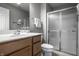 Bathroom featuring a shower with glass door, white sink, wood vanity and modern fixtures at 1805 Braeburn Dr, Carmel, IN 46032