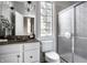 Bathroom featuring a double vanity, large mirror, globe lighting, shower, and window at 1805 Braeburn Dr, Carmel, IN 46032