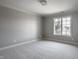 Empty bedroom with neutral carpet, trim, paint and window providing ample natural light at 1805 Braeburn Dr, Carmel, IN 46032