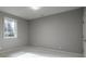 Empty bedroom with neutral carpet, trim, paint, door and a window providing natural light at 1805 Braeburn Dr, Carmel, IN 46032