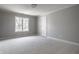 Empty bedroom with neutral carpet, trim, paint, door and a window providing natural light at 1805 Braeburn Dr, Carmel, IN 46032