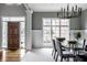 Elegant dining room with a modern chandelier, a glass table, and large windows at 1805 Braeburn Dr, Carmel, IN 46032