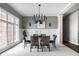 Stylish dining area with a statement chandelier, neutral color palette, and ample natural light at 1805 Braeburn Dr, Carmel, IN 46032