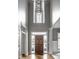 Grand foyer with a high ceiling, hardwood floors, and large windows for plenty of light at 1805 Braeburn Dr, Carmel, IN 46032