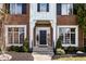 Inviting front entrance with a solid door, decorative sidelights, and manicured landscaping at 1805 Braeburn Dr, Carmel, IN 46032