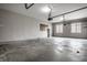 Large, empty garage with concrete floor, pegboard, shelving, and windows, offering plenty of storage space at 1805 Braeburn Dr, Carmel, IN 46032