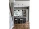 Kitchen island with seating and pendant lights near staircase featuring hardwood floors at 1805 Braeburn Dr, Carmel, IN 46032