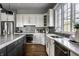 Bright kitchen featuring stainless steel appliances, island with counter seating, and stone backsplash at 1805 Braeburn Dr, Carmel, IN 46032