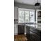 Kitchen with stainless steel dishwasher, view from window, and light stone backsplash at 1805 Braeburn Dr, Carmel, IN 46032