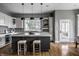 Spacious kitchen with dark island, marble countertops, pendant lights and a view of the outdoors at 1805 Braeburn Dr, Carmel, IN 46032
