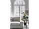 Bright living room features a large window, comfortable seating, and decorative accents at 1805 Braeburn Dr, Carmel, IN 46032