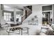 Open-concept living room with staircase, gray walls, glass coffee tables and hardwood floors at 1805 Braeburn Dr, Carmel, IN 46032