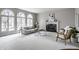 Bright living area with a cozy fireplace, comfortable seating, and large arched windows at 1805 Braeburn Dr, Carmel, IN 46032