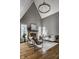 Spacious living room with high ceilings, a stone fireplace, modern seating, and large windows at 1805 Braeburn Dr, Carmel, IN 46032
