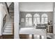 Spacious living room featuring a staircase, large windows, and comfortable seating at 1805 Braeburn Dr, Carmel, IN 46032