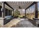 Inviting outdoor patio with a wooden pergola and a stone paver base, creating a relaxing ambiance at 1805 Braeburn Dr, Carmel, IN 46032