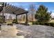 Outdoor patio with stone pavers, pergola, fire pit, and manicured landscaping, ideal for entertaining at 1805 Braeburn Dr, Carmel, IN 46032