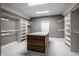 Large walk-in closet with center island, built-in shelving, and hanging rods for ample storage at 1805 Braeburn Dr, Carmel, IN 46032