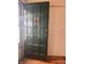 Green paneled front door featuring decorative glass panels, opening to a bright interior at 1843 Bauer Rd, Indianapolis, IN 46218