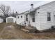 Exterior side view of home with white siding, detached garage, and yard at 1843 Bauer Rd, Indianapolis, IN 46218