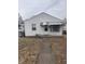 Charming single story home with white siding, front awning, and concrete walkway at 1843 Bauer Rd, Indianapolis, IN 46218