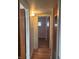 Hallway with hardwood floors and connecting doorways, offering a smooth transition between rooms at 1843 Bauer Rd, Indianapolis, IN 46218