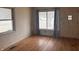 Bright living room with hardwood floors, large windows and neutral wall color at 1843 Bauer Rd, Indianapolis, IN 46218
