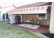 Charming backyard patio, featuring comfortable seating and a retractable awning for outdoor enjoyment at 1939 Crystal Bay E Dr, Plainfield, IN 46168