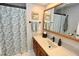 Bright bathroom with a wooden vanity, single sink, a shower with curtains, and neutral paint at 1939 Crystal Bay E Dr, Plainfield, IN 46168