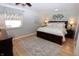Well-lit primary bedroom with hardwood floors and stylish decor at 1939 Crystal Bay E Dr, Plainfield, IN 46168