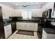 Modern kitchen with white cabinets, stainless appliances, mosaic backsplash and granite counters at 1939 Crystal Bay E Dr, Plainfield, IN 46168